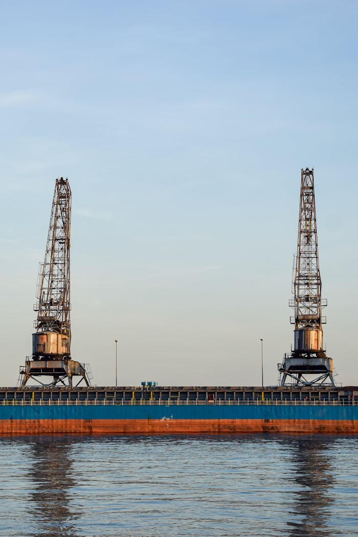 Two large industrial cranes at Rijeka port against a clear sky.